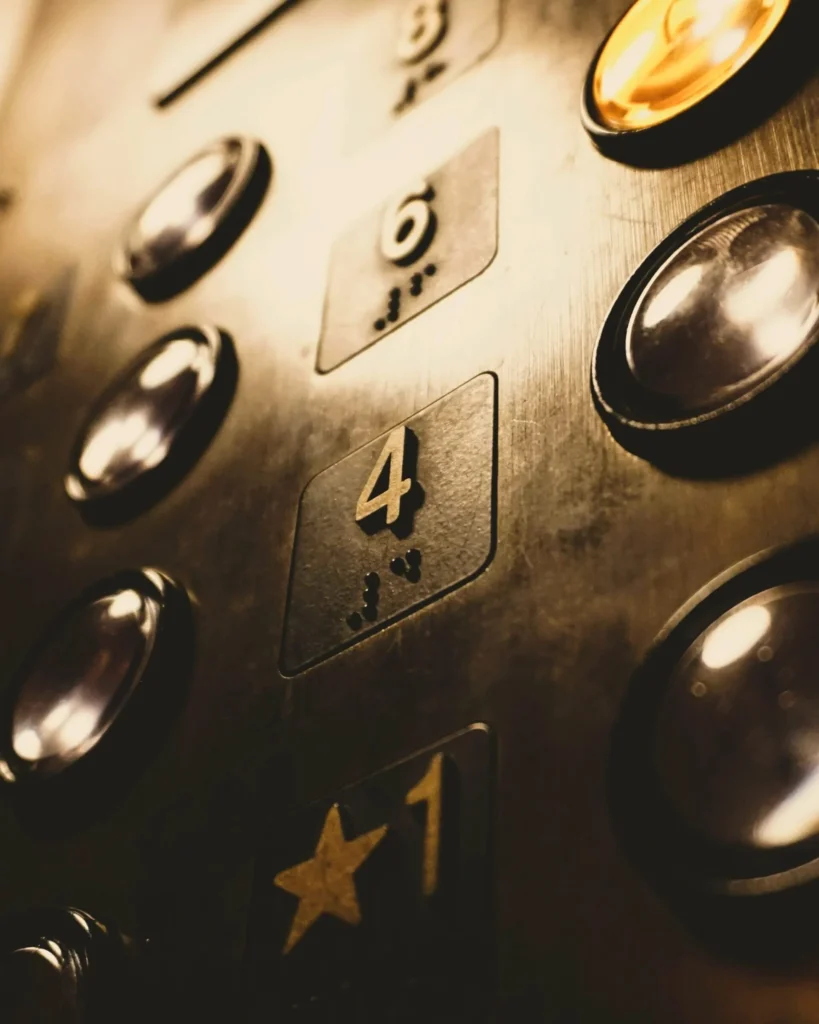 A close-up of illuminated elevator floor buttons, evoking the upward momentum of Kingster Local's Business Accelerator program.