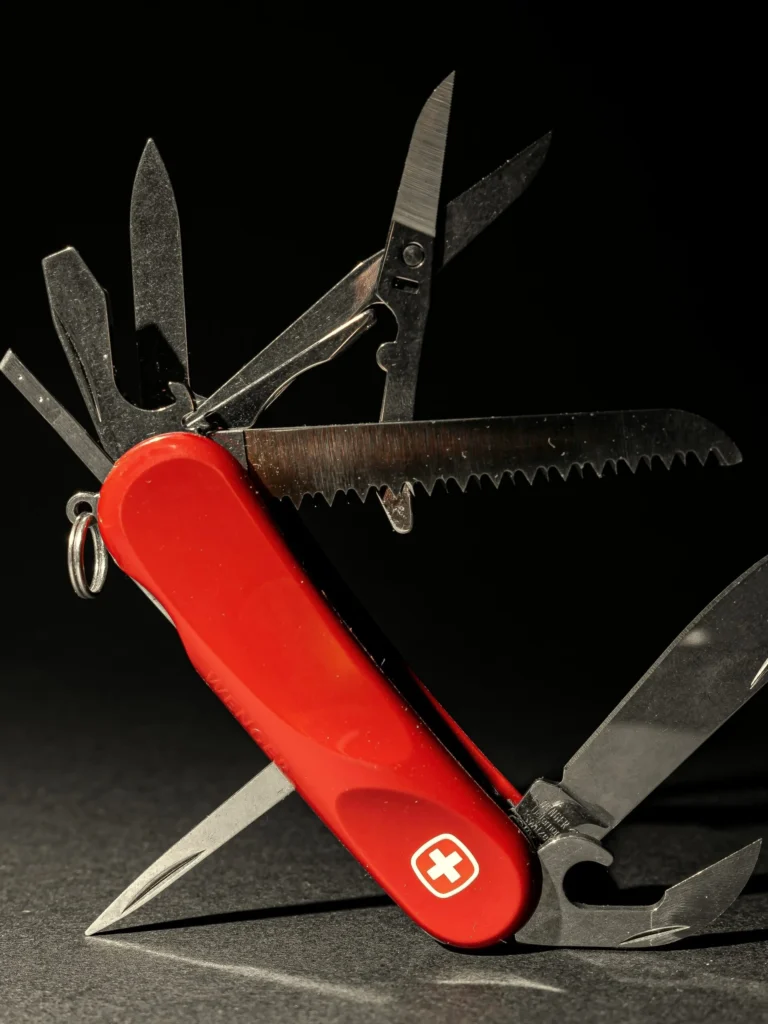 A red multi-tool knife opened to show its full set of blades, standing in for the do-it-all support of Kingster Local's Fractional Nerd.