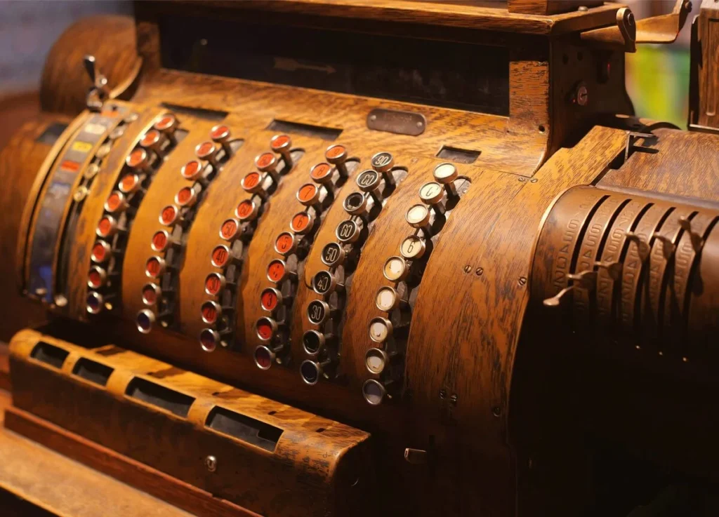 An ornate antique brass cash register with rows of price buttons, standing in for the local revenue that local SEO is built to drive.