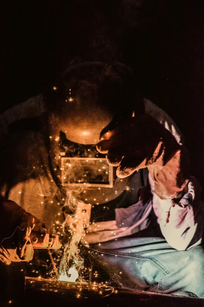 A welder sending sparks flying while fabricating a metal frame, standing in for Kingster Local's automated lead-generation systems.