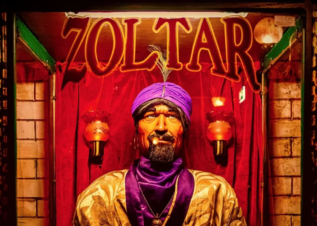 A vintage 'Zoltar' fortune-telling machine lit behind red curtains, a playful nod to the AI answer engines Kingster Local optimizes for.