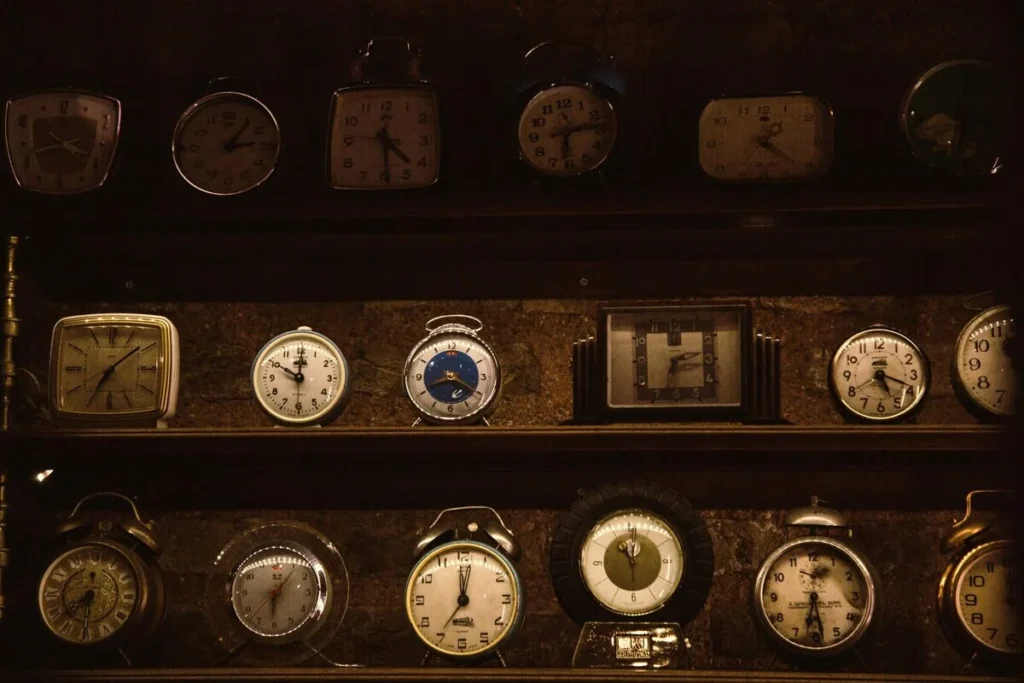 A wall lined with dozens of mismatched vintage clocks, standing in for the wide catalogs a Kingster Local eCommerce build organizes.