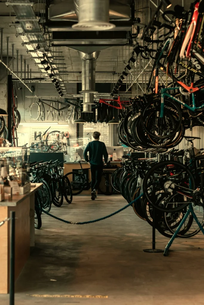 A bike shop owner walking through rows of bicycles, the kind of local business Kingster Local's ad campaigns are built to reach.